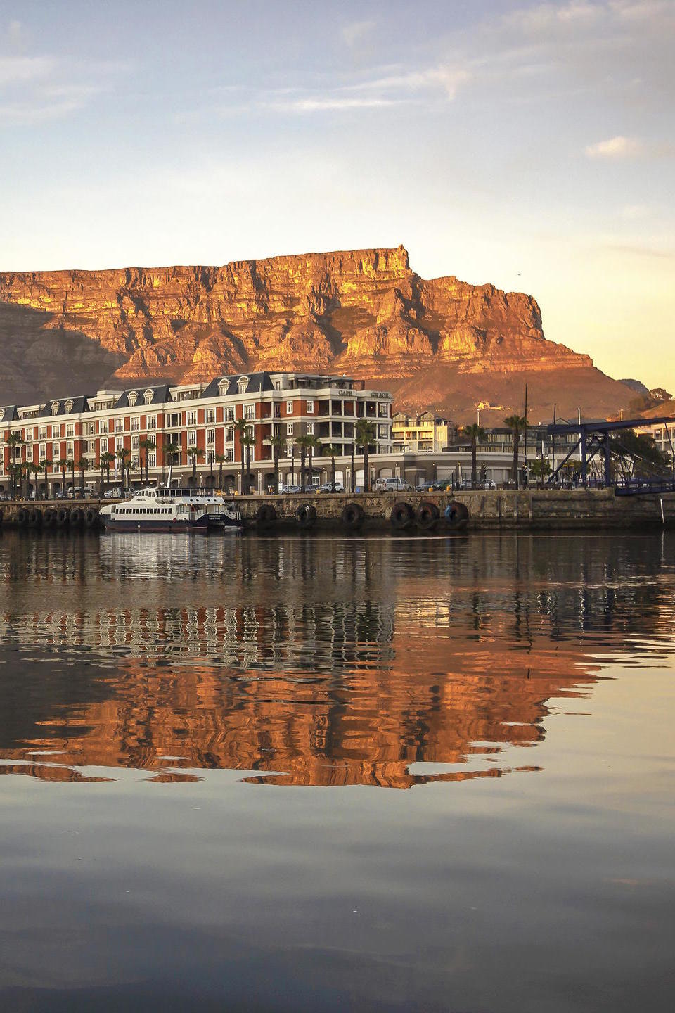 Cape Grace hotel with Table Mountain in the background at sunset